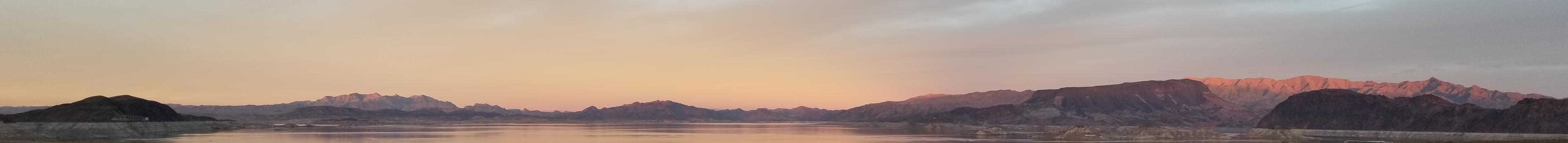 Panoramic view of sunset above a desert lake